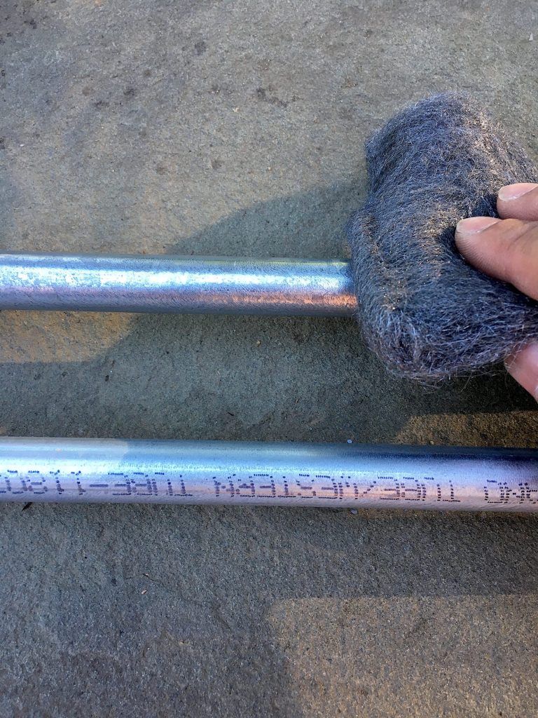 Coastal DIY: Mid-Century Modern Address Sign - Cutting metal conduit pipe #coastal #beachhousedecor #DIY #frugalLiving #housenumber